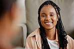 Happy, black woman and smile of a person on a home couch with happiness and a friend. Female face from Houston on a living room sofa looking at a person in a conversation and listening in a house