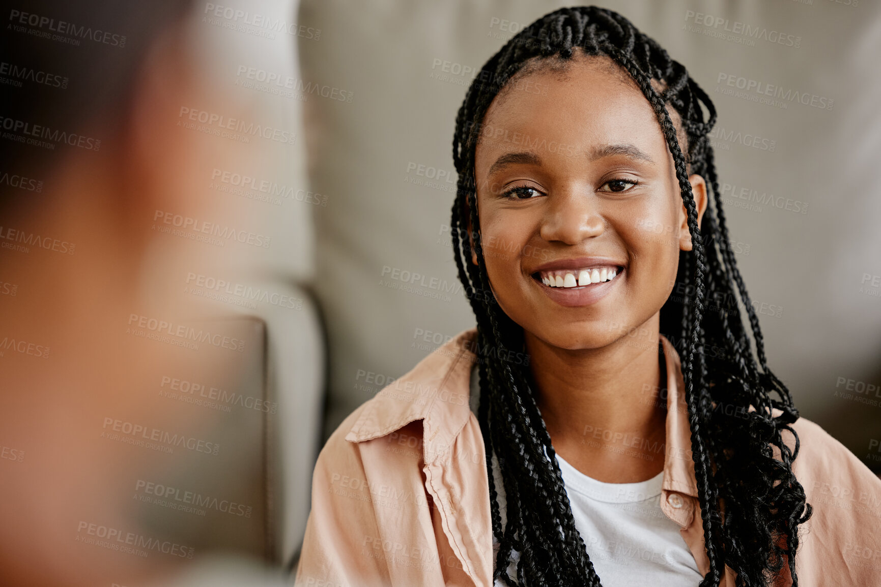 Buy stock photo Happy, black woman and smile of a person on a home couch with happiness and a friend. Female face from Houston on a living room sofa looking at a person in a conversation and listening in a house