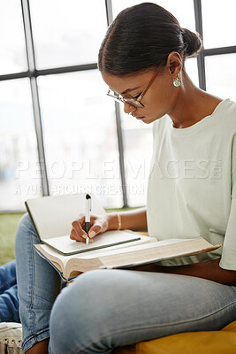 Buy stock photo University student woman writing notebook, reading research and learning for education, knowledge and project at campus in Colombia. College youth study textbook, exam notes and school library books