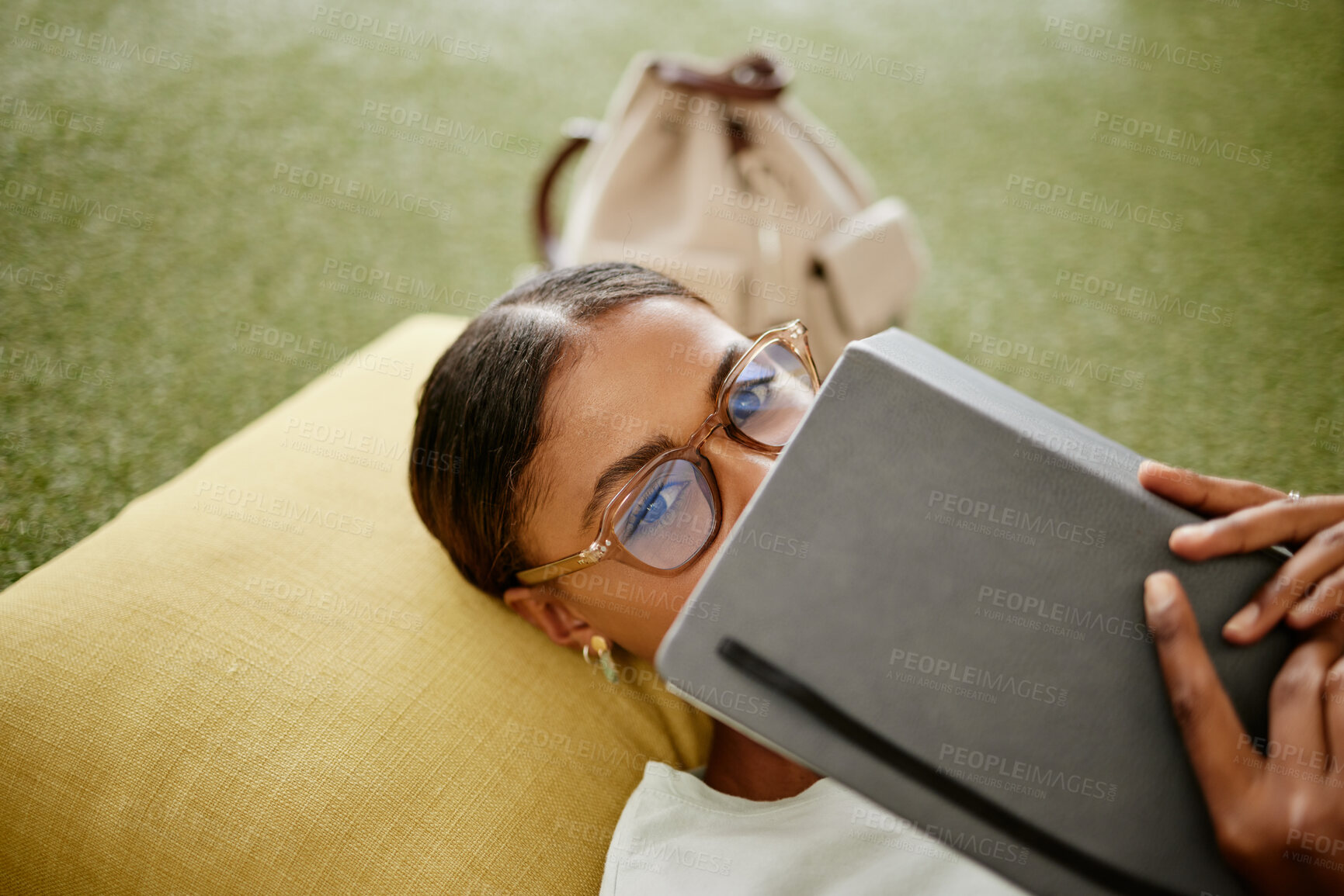 Buy stock photo Brazilian woman, notebook or education study on university college, school campus or relax grass turf. Portrait, vision glasses or student and learning goals, exam schedule or research library books