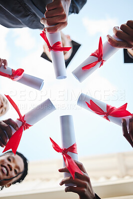 Buy stock photo Graduation, diploma and hands with a student group outside in a huddle or circle from below. Graduate, success and university with friends holding a degree after completing college education