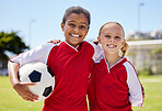 Portrait of girls on field, sports and soccer player, smiling with teammate. Soccer ball, football and young kids having fun on summer day before match or game. Team, friends and teamwork in sport