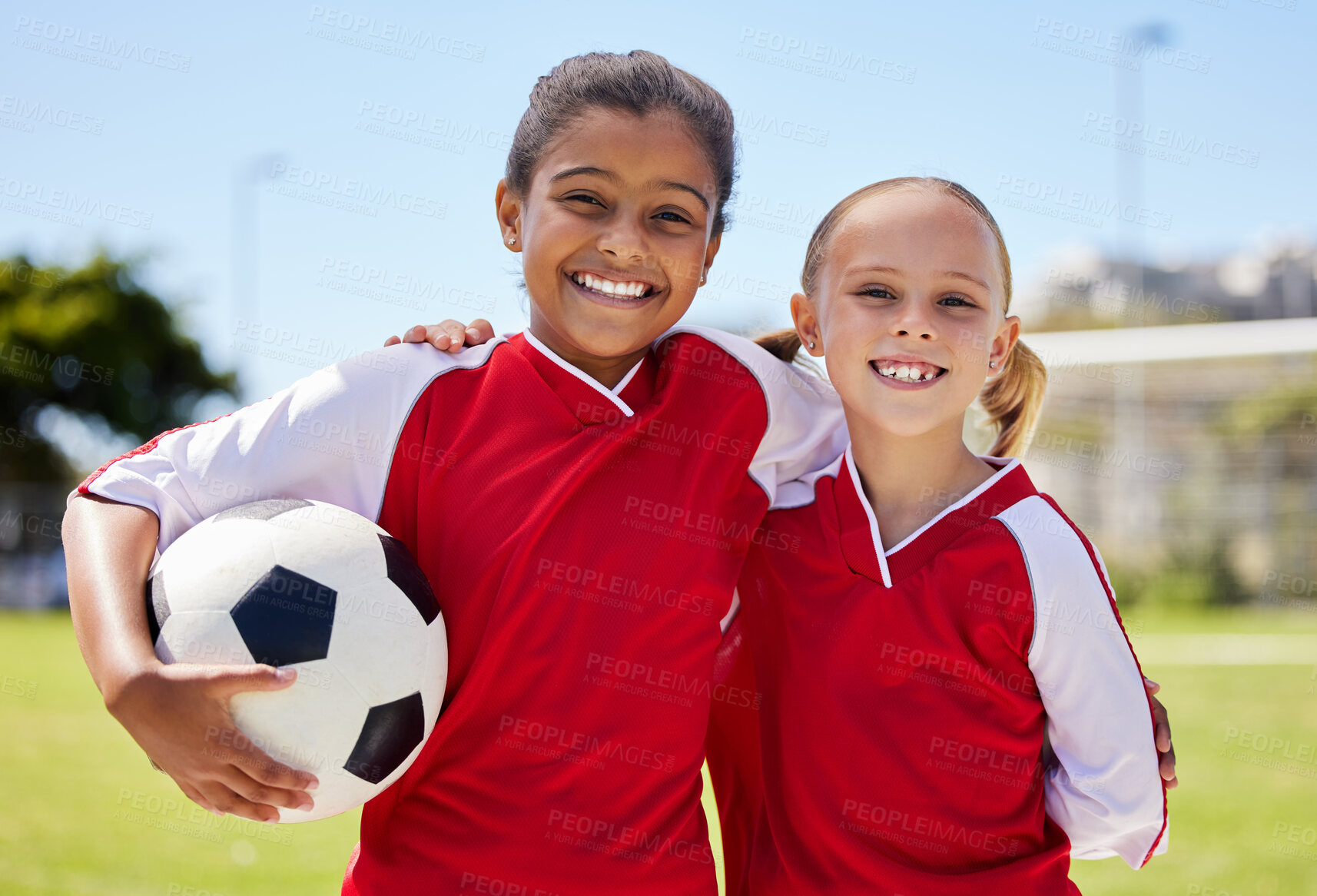 Buy stock photo Portrait of girls on field, sports and soccer player, smiling with teammate. Soccer ball, football and young kids having fun on summer day before match or game. Team, friends and teamwork in sport