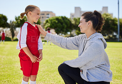 Buy stock photo Girl, coach and soccer for motivation, inspiration and help on field for better performance in sport. Woman, child and football together on grass talking for advice, learning and guidance in game