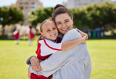 Buy stock photo Portrait of mother and girl hug at soccer training, bonding and embracing on a field. Sport, fitness and support by parent for child hobby and passion, enjoying morning activity  and football outdoor
