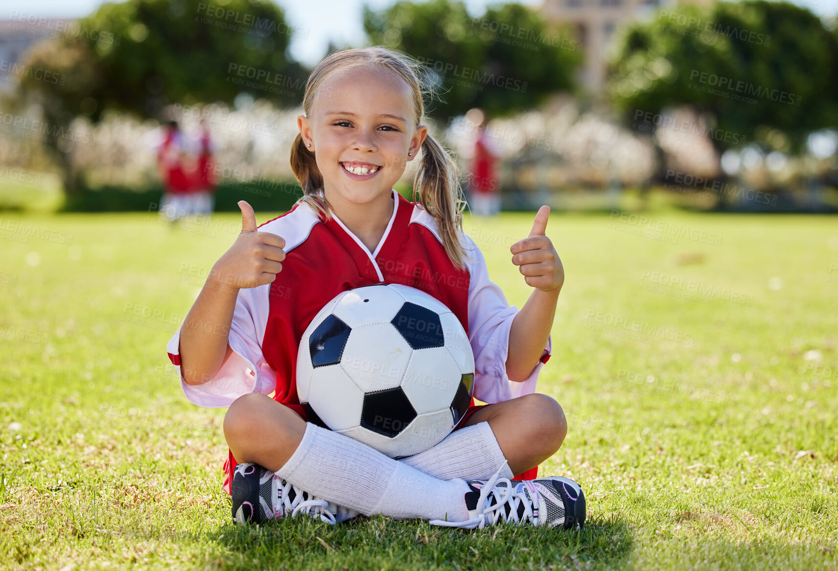 Buy stock photo Ball, soccer and girl thumbs up on field, training and sports activity outdoor. Portrait of young sport athlete, health and exercise with child relax on grass, prepare for game, happy and smile