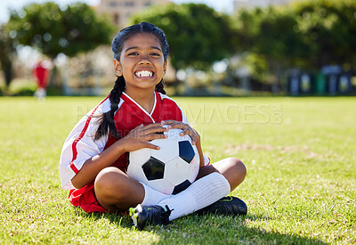 Buy stock photo Sports, children and girl soccer player relax on grass with soccer ball, happy and excited at training. Fitness, smile and portrait of Indian child on field, ready for cardio, energy football workout
