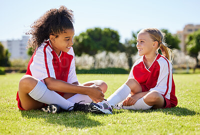 Buy stock photo Field, friends and girl soccer children enjoy friendly conversation with smile at game break. Interracial friendship with happy kids smiling together on sports ground at football  match in USA.