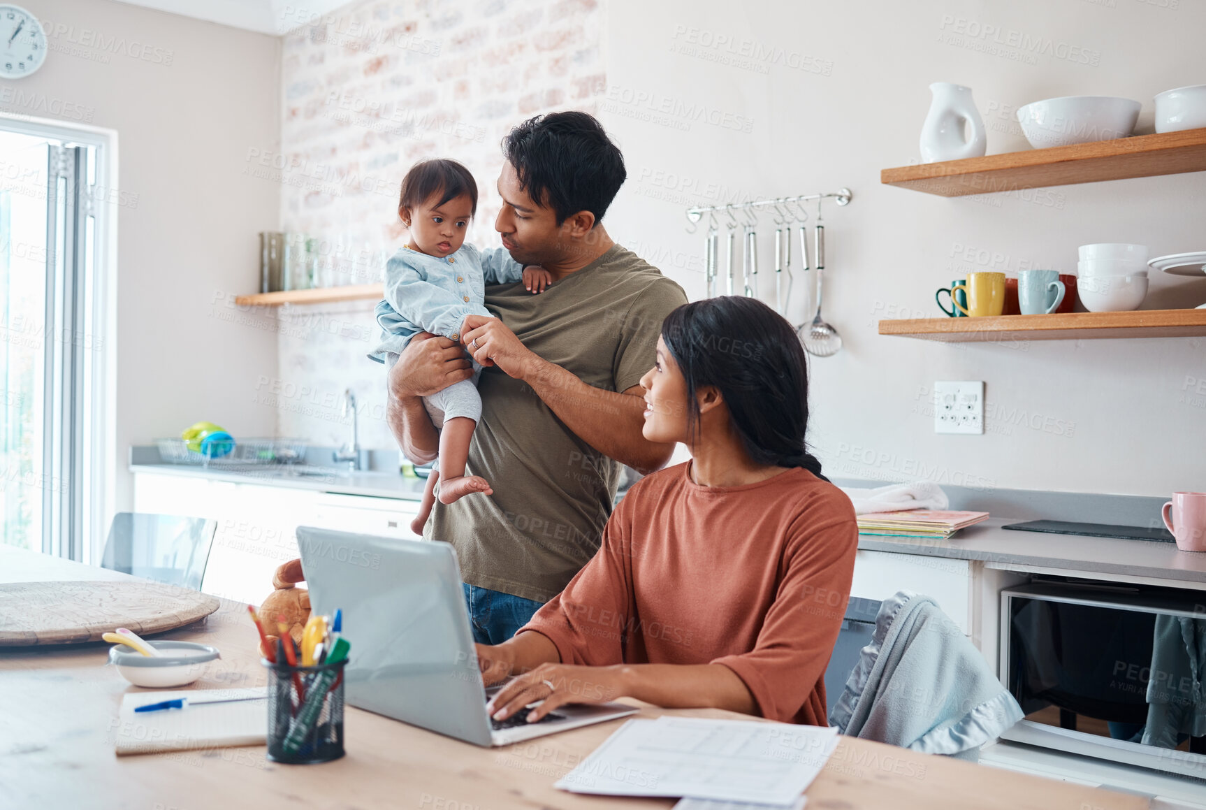 Buy stock photo Family, baby and down syndrome while mother work online with laptop in kitchen. Mom, father and child play while mother use computer for learning, education or college on the internet in house