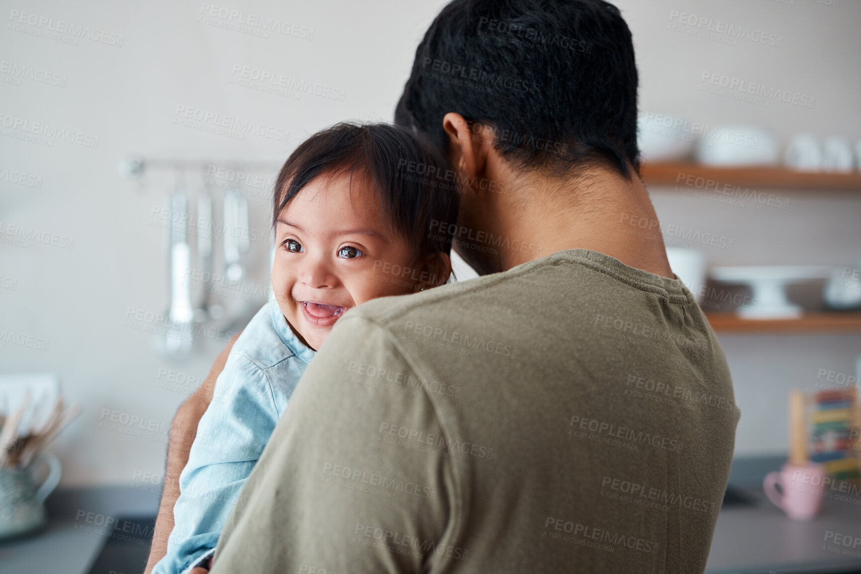 Buy stock photo Down syndrome, baby and father bonding in a kitchen, happy and relax in their home together. Disability, development and child care for special needs with loving parent holding and comfort newborn