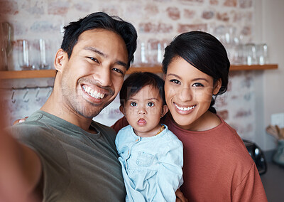Buy stock photo Happy asian family, smile for selfie in relax, love and care in happiness together at home. Portrait of a father, mother and Down syndrome baby smiling for photo in loving relationship