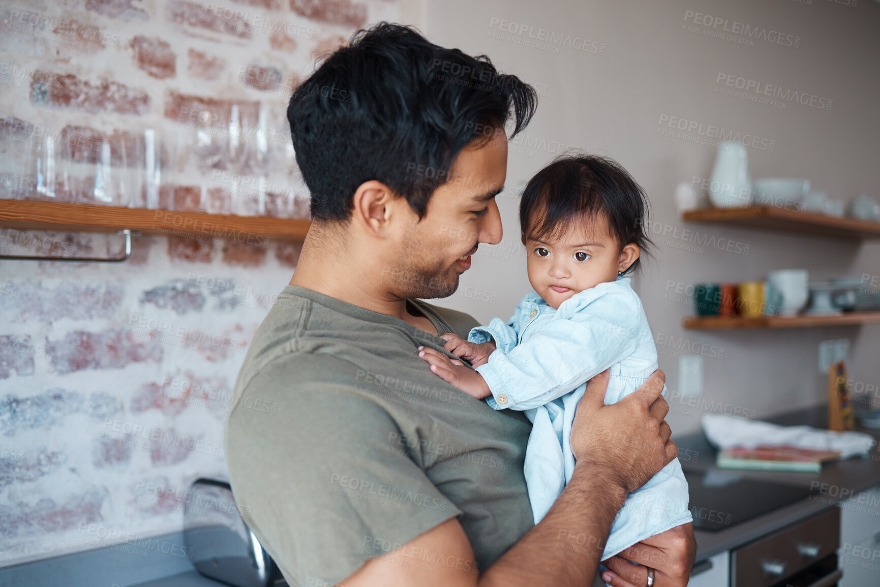 Buy stock photo Down syndrome, love and father with smile for baby in the kitchen of their house together. Young child with development disability and special needs with care from happy dad in their family home