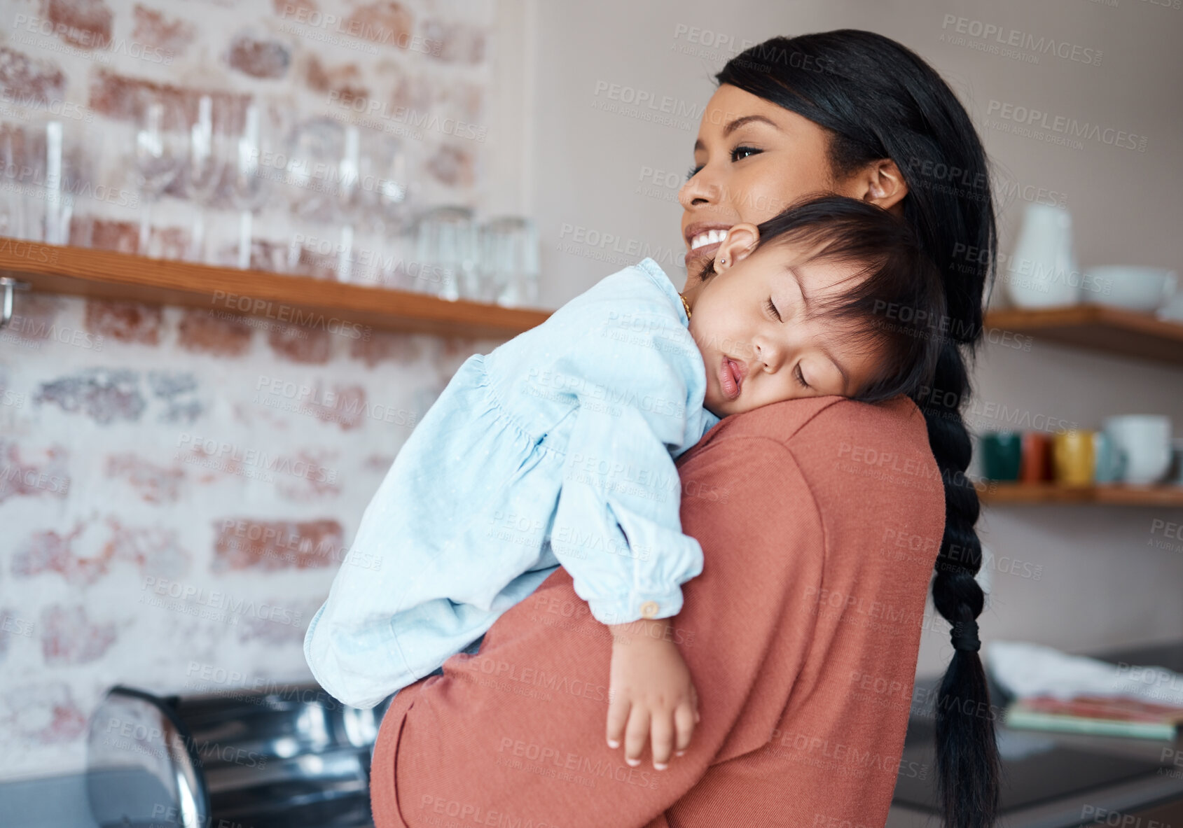 Buy stock photo Care, love and mother holding sleeping baby with down syndrome in the kitchen of their house. Newborn child with development problem sleep with happy mom with smile and comfort in their family home