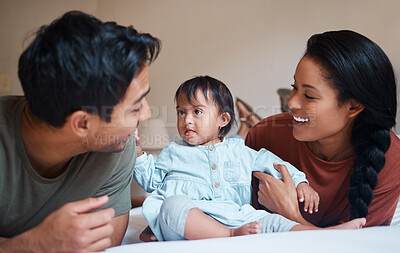 Buy stock photo Down syndrome, mother and father bonding with child smile, happy and together at home for quality time. Family, man and woman with baby, kid and newborn with disability, special needs and cuddle.