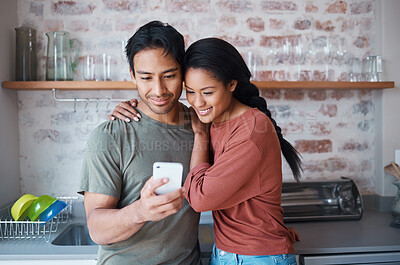 Buy stock photo Couple, smile and phone in kitchen for social media, meme or comic video on web. Man, woman and happy with smartphone while reading funny blog, chat or news on app while relax together in home