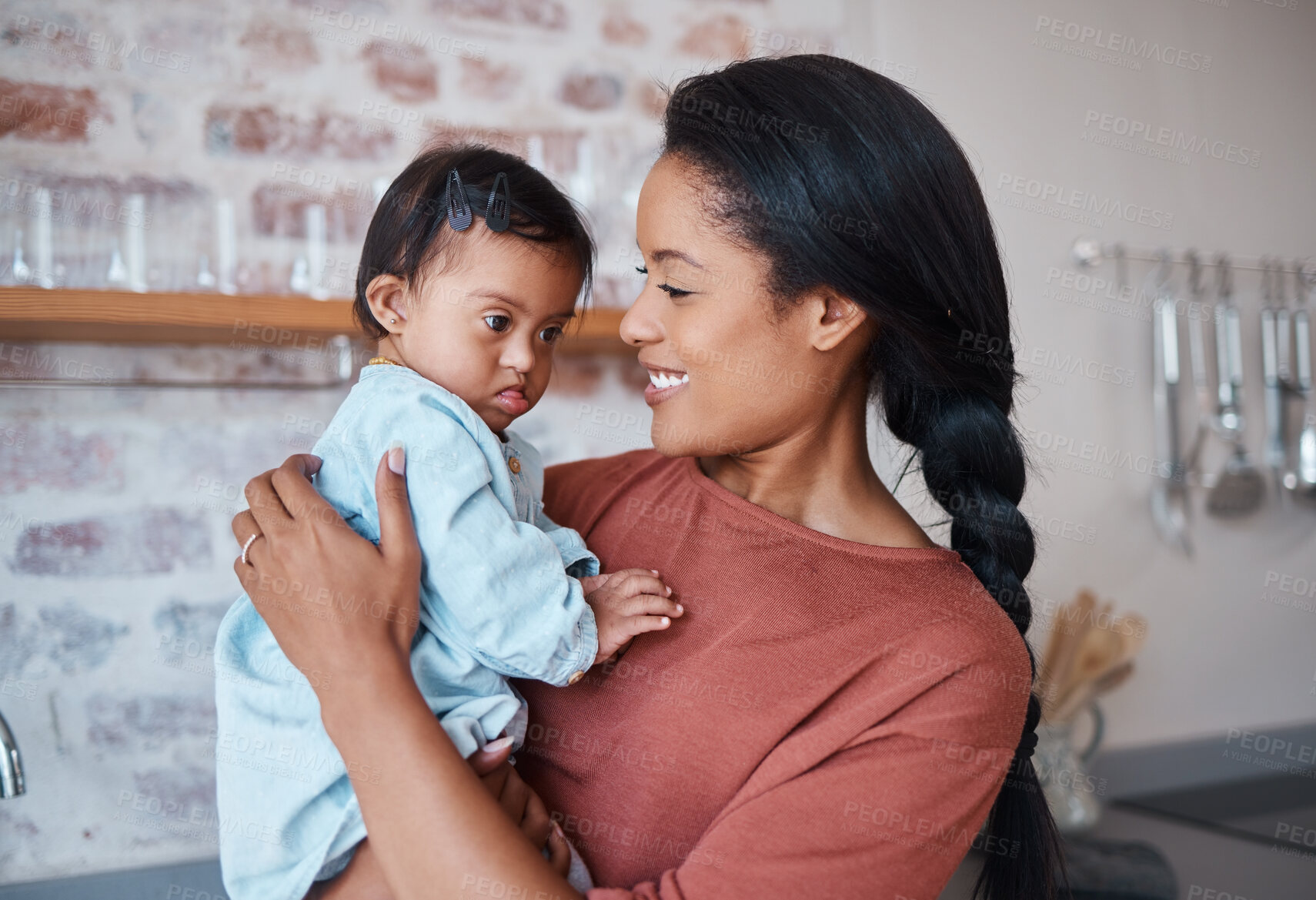 Buy stock photo Disability baby and mother holding down syndrome child with love and care in home with acceptance. Puerto Rico family with young disabled kid and support of mom with cheerful smile embracing her.

