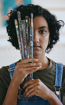 Buy stock photo Creative, woman with paint brushes in hand and art student from India holding brush over eye. Creativity, idea and painting, portrait of Indian girl artist with painter tools in hand in school studio