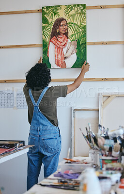 Buy stock photo Painter, artist and wall hanging painting in studio to dry before exhibition, sale or display. Art, creative and woman with portrait of girl in paint in workshop with canvas, brush and color in Paris
