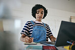 Black woman writing notes, studying on laptop and working on living room desk from home. African American girl, digital learning from inside her house and working on elearning education course online