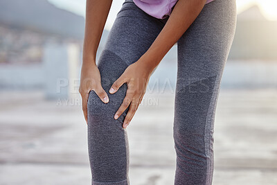 Buy stock photo Knee injury, fitness and woman with pain while training for health in the city of Turkey. Legs and hands of an athlete runner with medical emergency after running, cardio or workout accident 