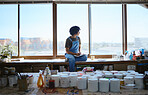 Idea, creative and woman thinking while drawing with inspiration at a window in a studio. Indian artist, designer or creativity student with goal and vision for design job on paper at a workshop