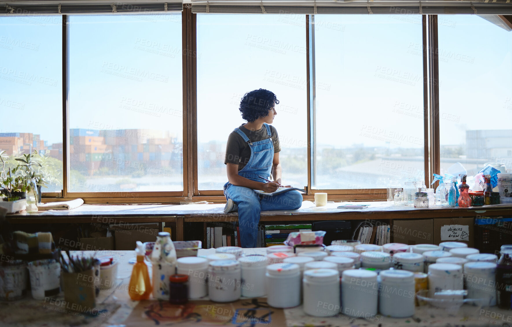 Buy stock photo Idea, creative and woman thinking while drawing with inspiration at a window in a studio. Indian artist, designer or creativity student with goal and vision for design job on paper at a workshop