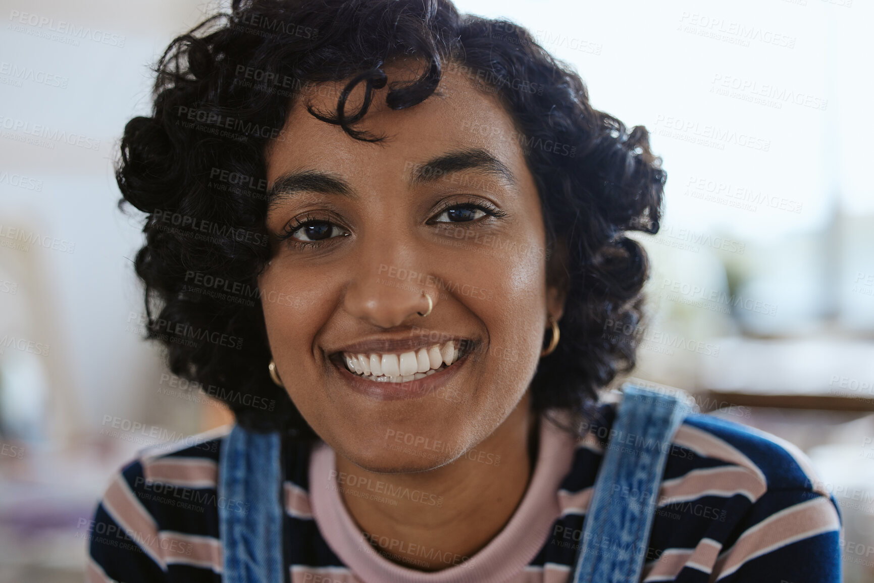 Buy stock photo Face, portrait and happy with a young woman feeling carefree or cheerful with a smile closeup. Head, teeth and nosering with an attractive, trendy or edgy female with a piercing on a blur background