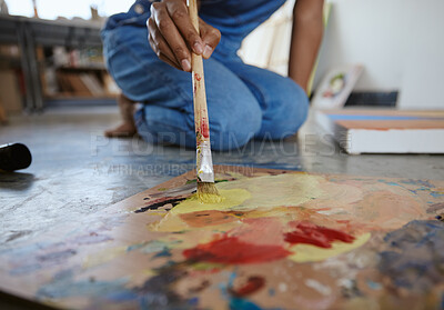 Buy stock photo Artist woman, painting and paint brush on art studio floor being creative and working with watercolor for artwork project. Talented, skill and canvas closeup with hand of a female painter in workshop