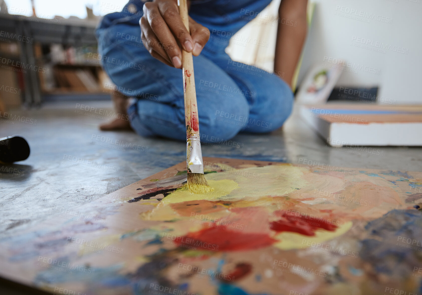 Buy stock photo Artist woman, painting and paint brush on art studio floor being creative and working with watercolor for artwork project. Talented, skill and canvas closeup with hand of a female painter in workshop
