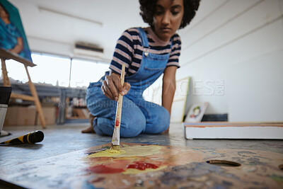 Buy stock photo Woman artist, painting and canvas on floor in art studio for creative exhibition, design academy and students home workshop, school or gallery. Designer, watercolor painter and brush stroke project