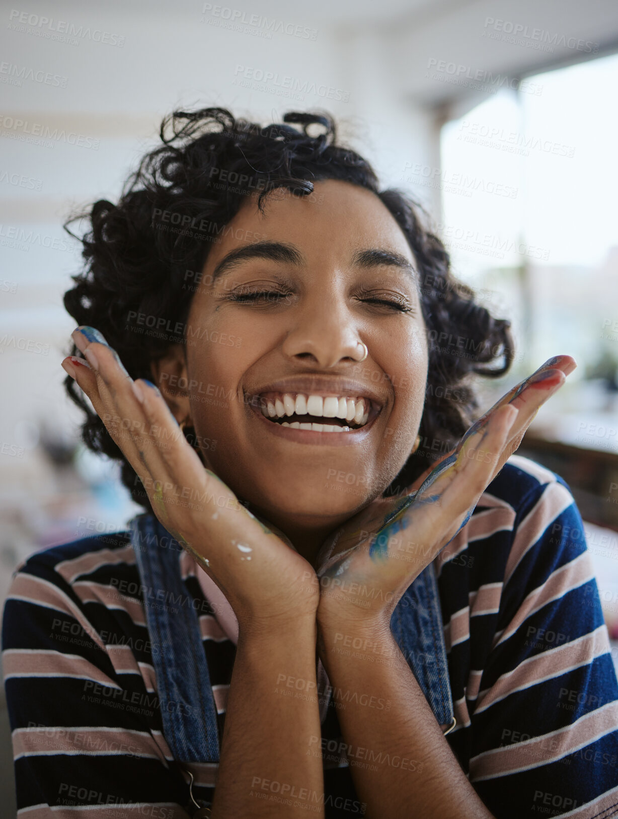 Buy stock photo Woman artist, smile, happy and excited in her work studio, her hand with paint. Young painter, art and playful while working in workshop, painting and creative with watercolor during a break.