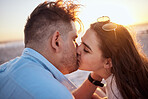 Kissing, couple love and sunset beach bonding, relax and break on summer vacation together outdoors. Man, woman and young people face in loving relationship, honeymoon date and romance sea holiday