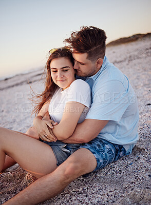 Buy stock photo Couple, relax and hug for love on a beach sitting and enjoying time together in the outdoors. Young man hugging woman relaxing on a sandy ocean coast in Costa Rica for romantic relationship in nature