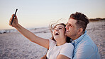 Phone selfie, love and relax couple on the beach have outdoor fun, laugh and enjoy quality bonding time together. Happy, smile and hug from romantic man and woman with smartphone in Sydney Australia