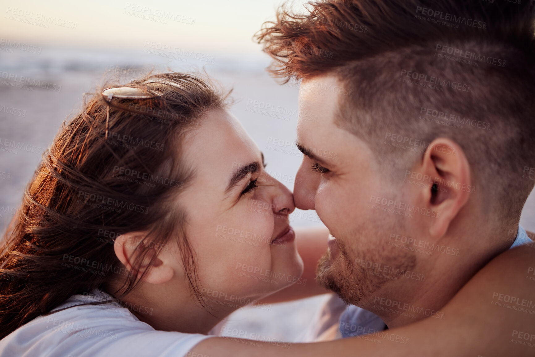 Buy stock photo Love, happy and face of couple on the beach smile with connection, bonding and happiness on ocean holiday. Hug, partnership and romantic man and woman enjoy quality time together in Rio de Janeiro