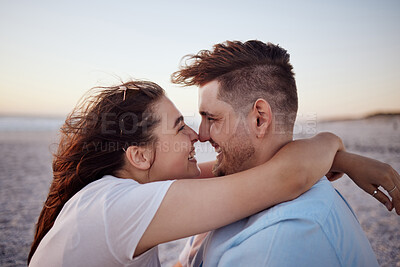 Buy stock photo Couple with love, happy and together on a beach during vacation in hawaii. Man and woman hug affection anniversary, bonding and relax outdoor in summer. Romantic getaway for two at the sea in sunset