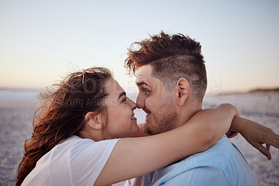 Buy stock photo Real couple at beach with nose touching in love, dating and romantic affection. Love, real relationship and funny man and woman by ocean sunset happy, embrace and playful comic on summer holiday