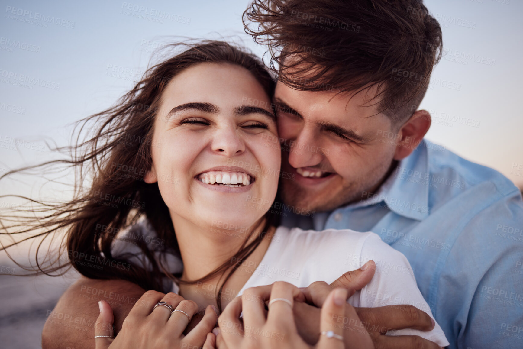 Buy stock photo Couple, happy and sunset together for honeymoon with hands for hug at beach in zoom. Man and woman with smile on face for romance, happiness and love on vacation, travel or holiday by sea in Hawaii