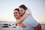 Beach, love and couple with man carrying girl on his back, happy and smiling. Holiday, dating and romantic vacation by the sea. Young happy couple enjoying sunset, ocean and summer fun together