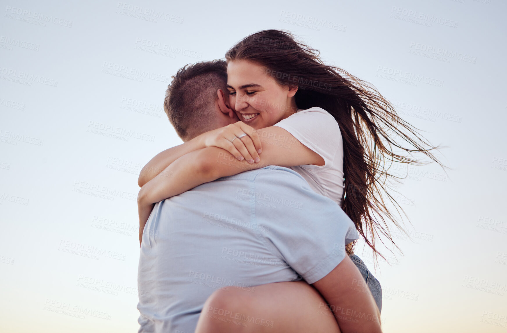 Buy stock photo Love, hug and couple at sunset, excited and cheerful while bonding in nature. Freedom, care and loving woman holding man, enjoy summer romance and relationship with sweet affection outdoors together