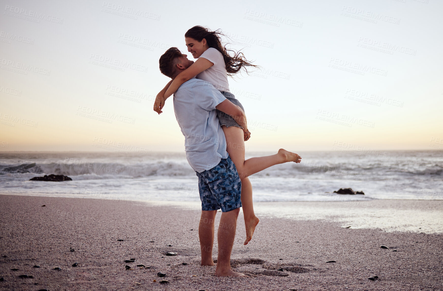 Buy stock photo Happy couple at beach lift and hug to celebrate love on romantic sunset tropical ocean water Hawaii luxury vacation travel or holiday. Woman and man dating and celebration for engagement announcement