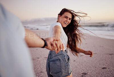 Buy stock photo Happy, woman and hand holding at the beach of a couple having fun together with love. Happiness of a girlfriend and boyfriend smile on sea sand near ocean waves at sunset during a summer travel