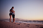 Love, beach and footprints in the sand with couple at sunset for support, hug or happy on Cancun summer vacation. Trust, goals and hope with man and woman by the sea on holiday for travel and romance