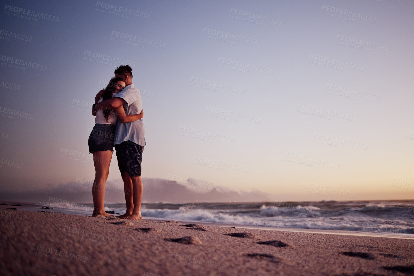 Buy stock photo Love, beach and footprints in the sand with couple at sunset for support, hug or happy on Cancun summer vacation. Trust, goals and hope with man and woman by the sea on holiday for travel and romance