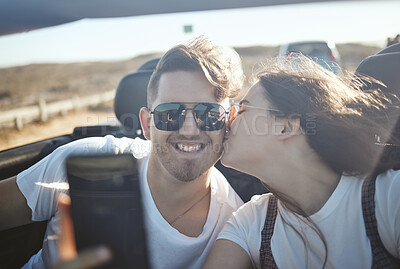 Buy stock photo Selfie, kiss and road trip with a real couple driving on the one road for vacation, honeymoon or romance. Love, happy and kissing with a young man and woman taking a photograph while sitting in a car