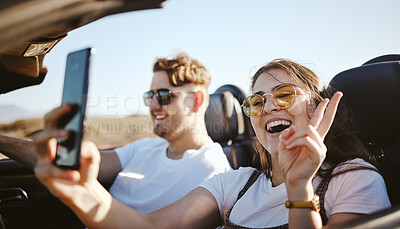 Buy stock photo Couple, phone and travel for selfie in car for social media for summer vacation and laugh together. Happy man and woman on holiday road trip on mobile smartphone with a peace sign