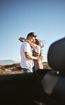 Road trip, travel and couple kiss and hug for holiday, vacation or outdoor adventure with blue sky mock up advertising or marketing. Love, romantic people with car by countryside road summer mockup