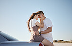 Love, relax and couple embrace at car for intimate driving break together in Los Angeles, USA. Young, happy and caring people enjoy summer sunshine with romantic touch while leaning on vehicle. 