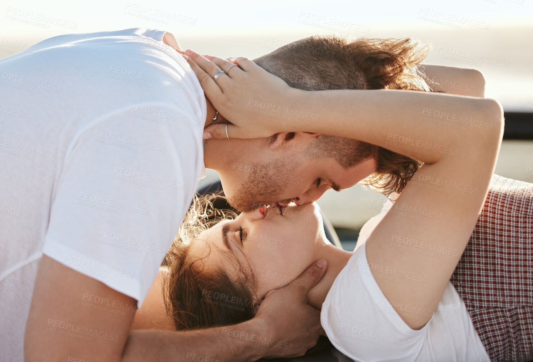 Buy stock photo Couple, love and kiss with a man and woman on a road trip for their honeymoon, vacation or travel. Romance, kissing and together with a male and female enjoying a date together during summer