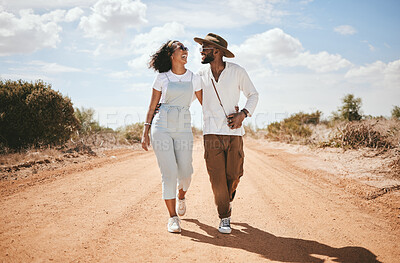 Buy stock photo Love, couple and summer with a black woman and man walking on a sand road in the dessert while on vacation. Romance, dating and holiday with a young male and female on a walk together in nature